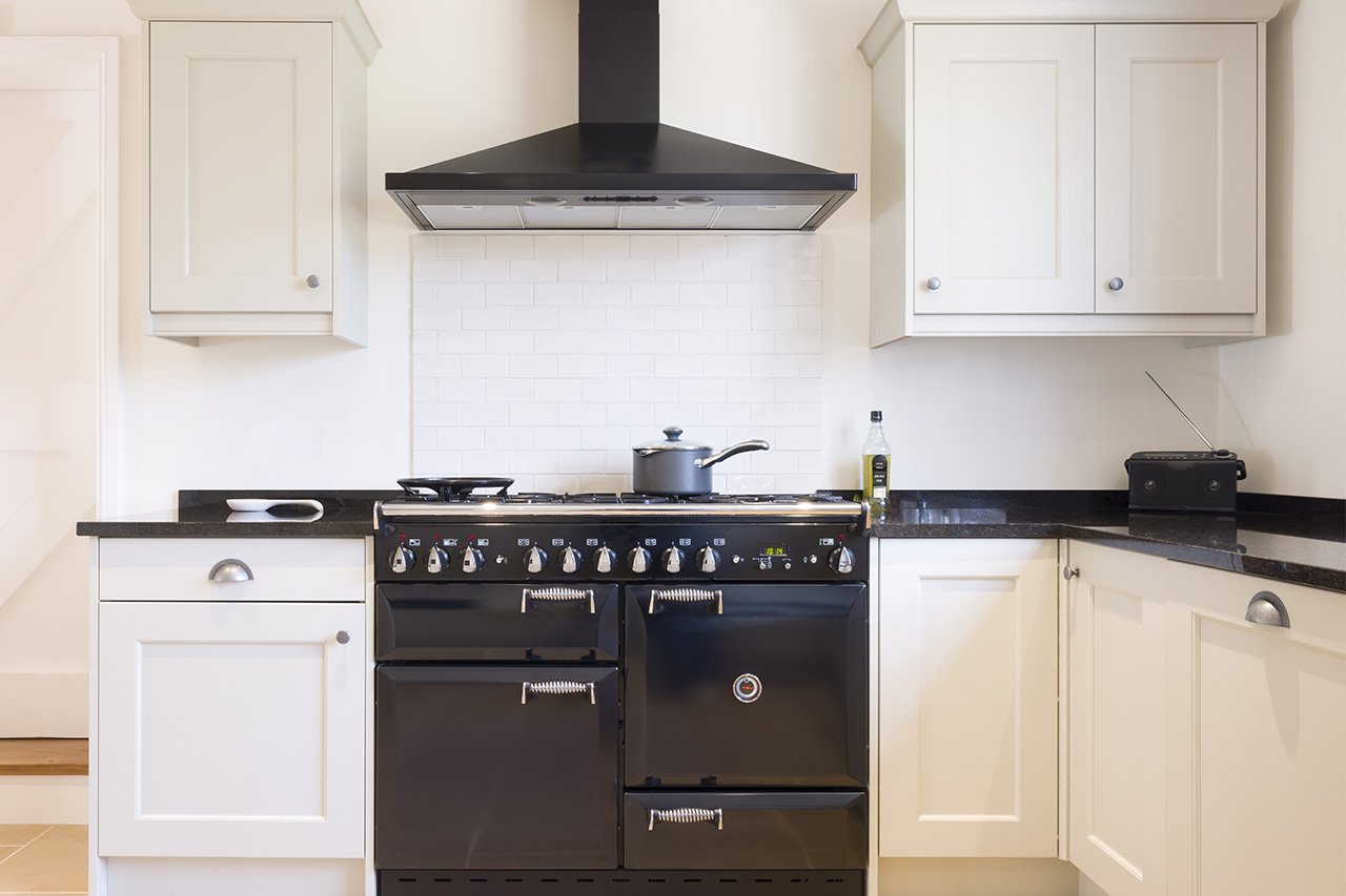 Black oven range with black vent hood